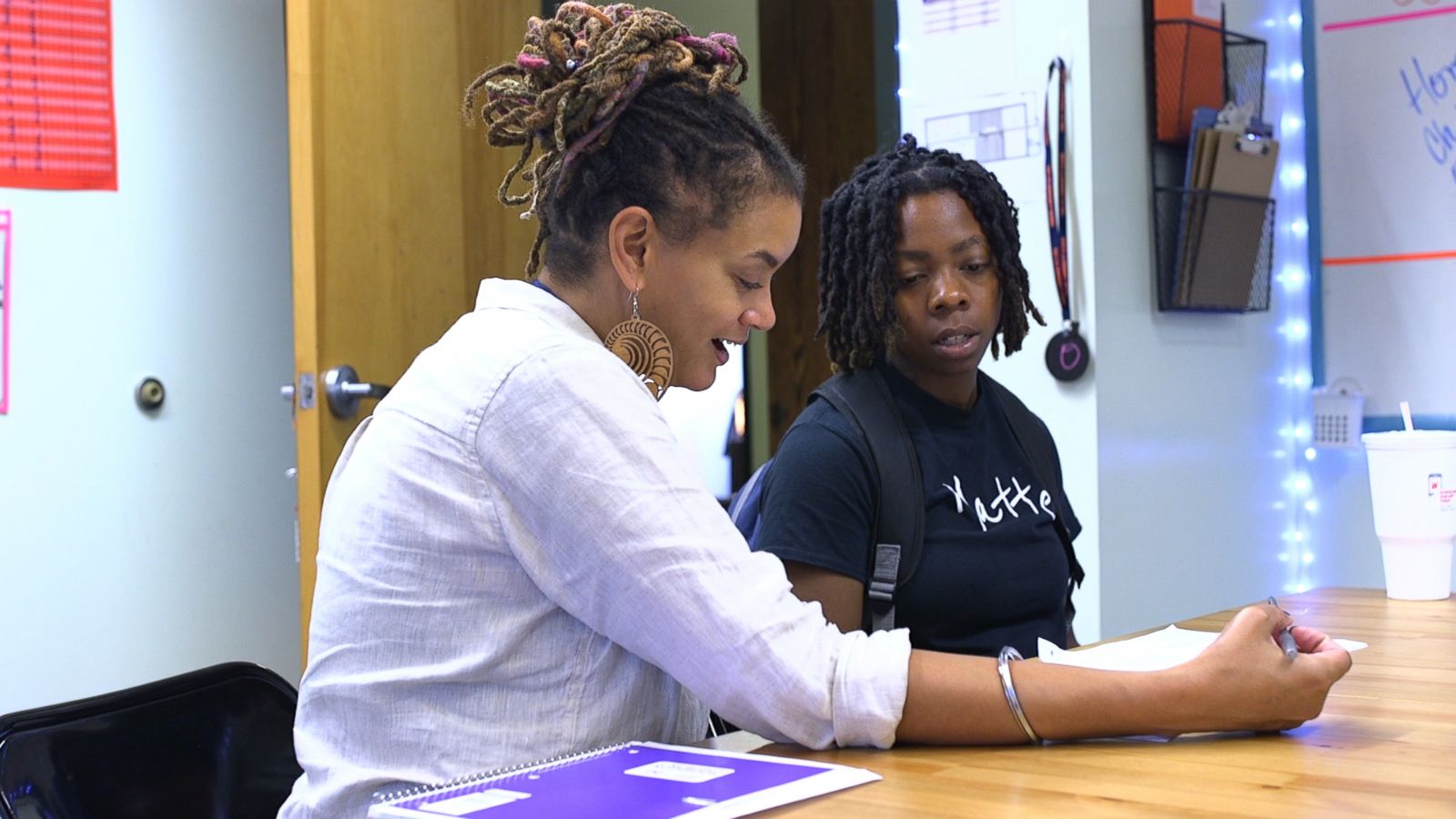 PHOTO: I-Sha-Le Watson goes over school work with a teacher.