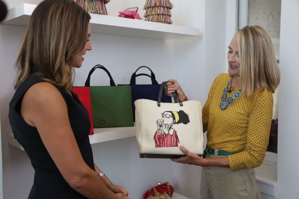 PHOTO: Elyce Arons, right, shows off a handbag with a drawing of her friend, the late Kate Spade, to ABC News' Paula Faris, left.