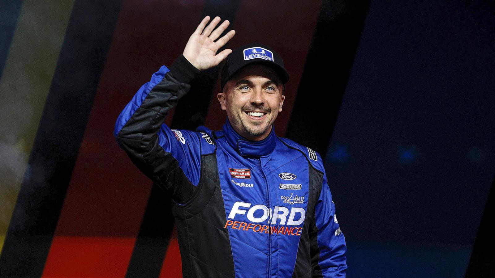 PHOTO: Frankie Muniz waves to fans as he walks onstage during driver intros prior to the NASCAR Craftsman Truck Series Kubota Tractor 200 at Kansas Speedway, Sept. 27, 2024, in Kansas City, Kan.