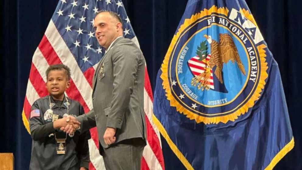 PHOTO: Adam Colon, the chief of police of Franklin, Ohio, shakes hands with Devarjaye "DJ" Daniel during a ceremony where DJ was named an honorary officer of the Franklin Police Division.