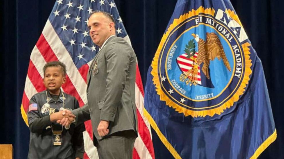 PHOTO: Adam Colon, the chief of police of Franklin, Ohio, shakes hands with Devarjaye "DJ" Daniel during a ceremony where DJ was named an honorary officer of the Franklin Police Division.