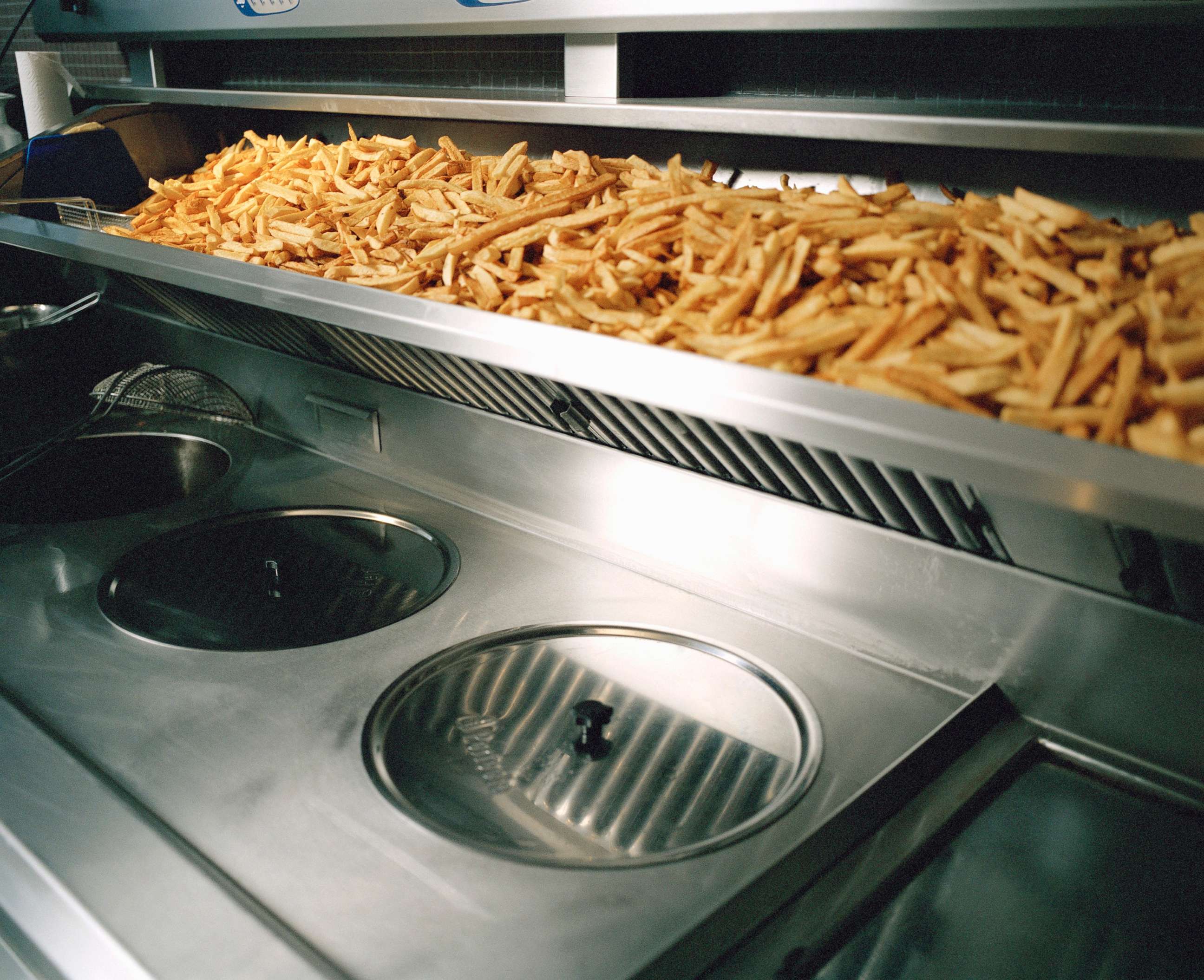 PHOTO: French fries are seen on a shelf above deep fryer in this undated stock photo.
