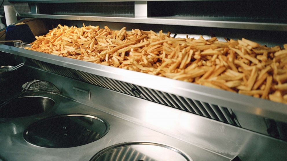 PHOTO: French fries are seen on a shelf above deep fryer in this undated stock photo.