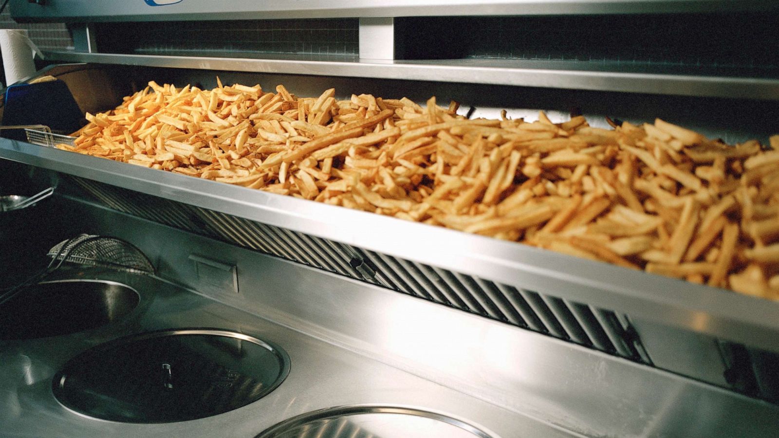 PHOTO: French fries are seen on a shelf above deep fryer in this undated stock photo.