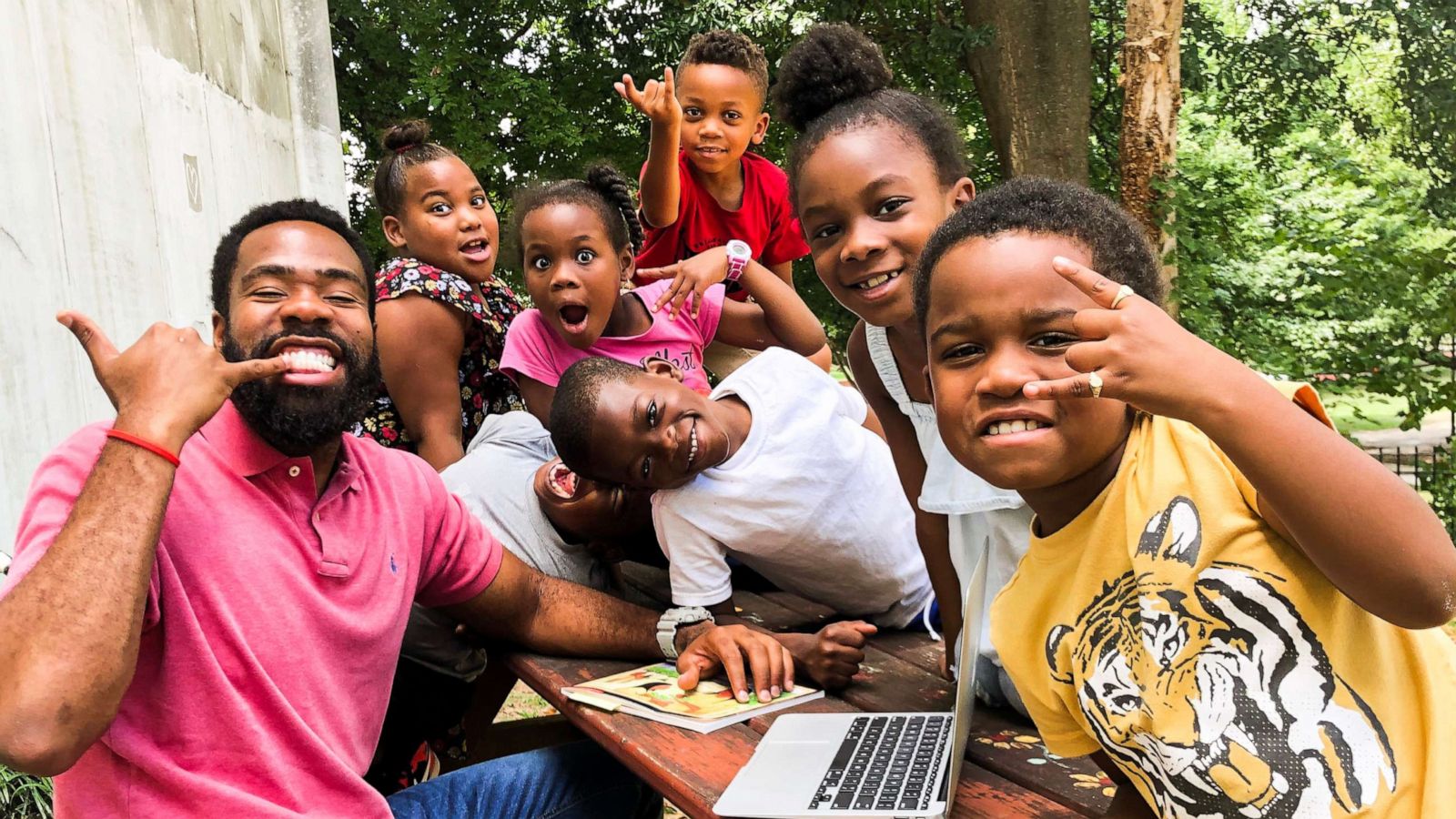 PHOTO: Sammy Rigaud, a second-grade teacher at The Kindezi School at Old Fourth Ward in Atlanta, Georgia, smiles alongside students.