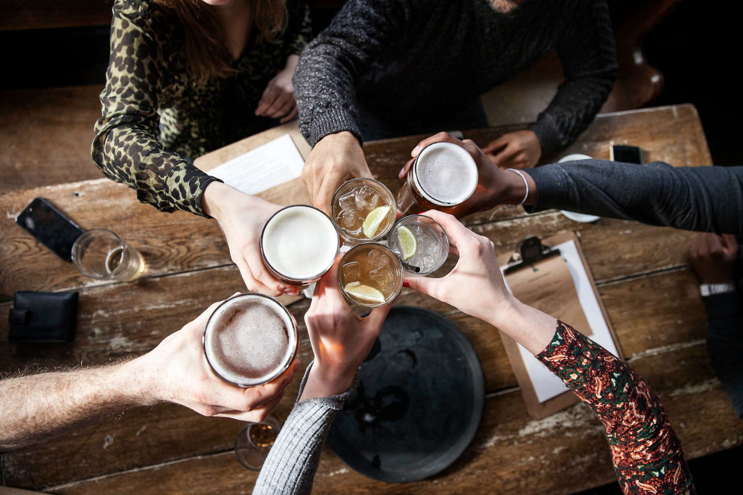 STOCK PHOTO: friends toast at a bar.
