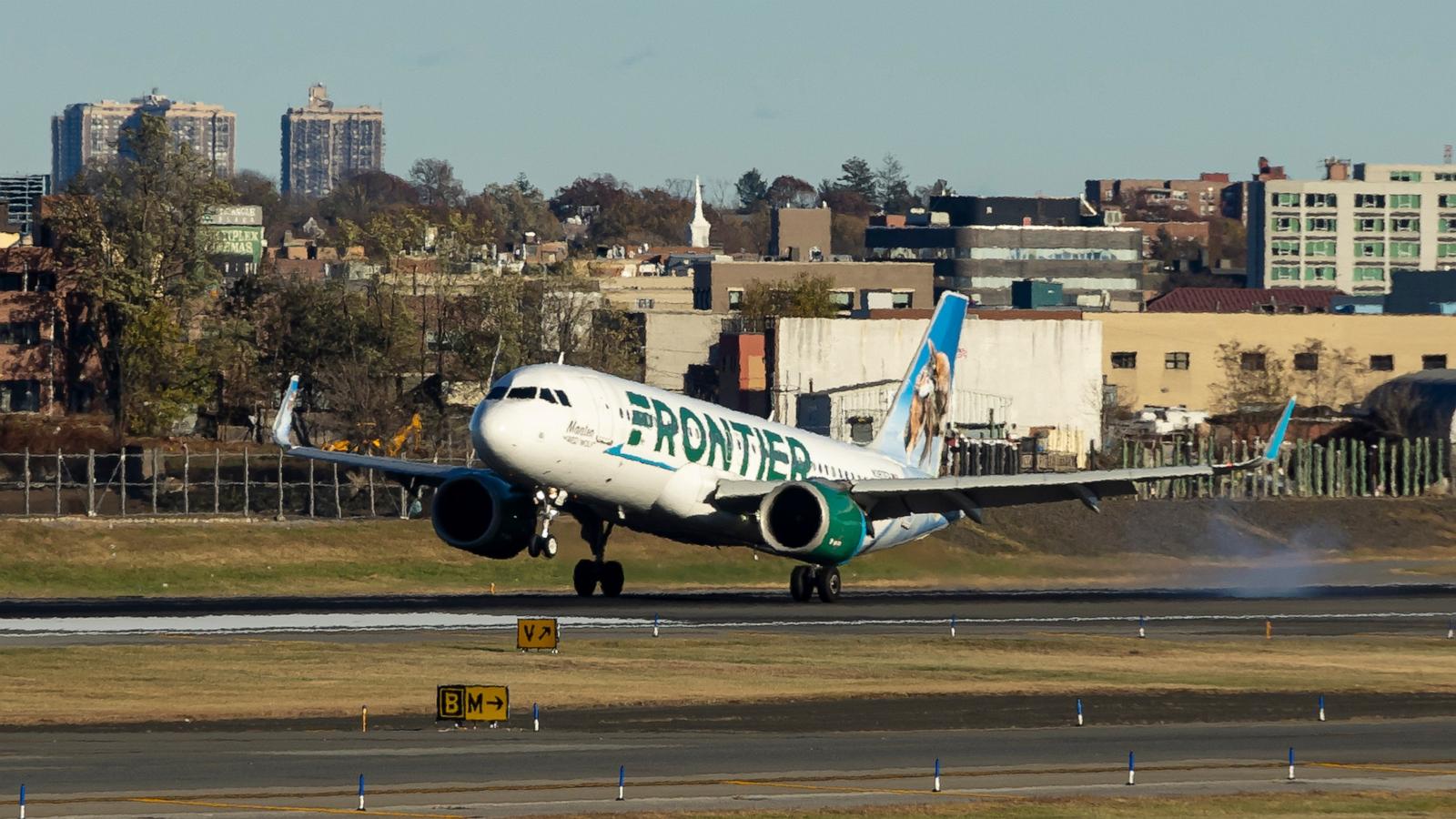 PHOTO: Frontier Airlines Airbus A320neo passenger aircraft spotted on final approach flying, landing and taxiing on the runway and taxiway of LaGuardia airport in NYC.