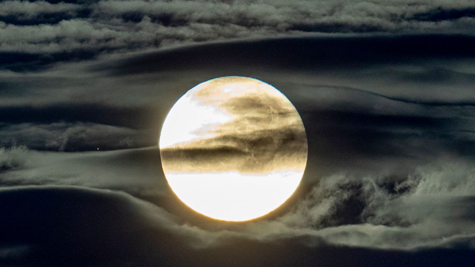 PHOTO: The full moon shines through clouds seen from the outskirts of Frankfurt, Germany, Sept. 2, 2020.