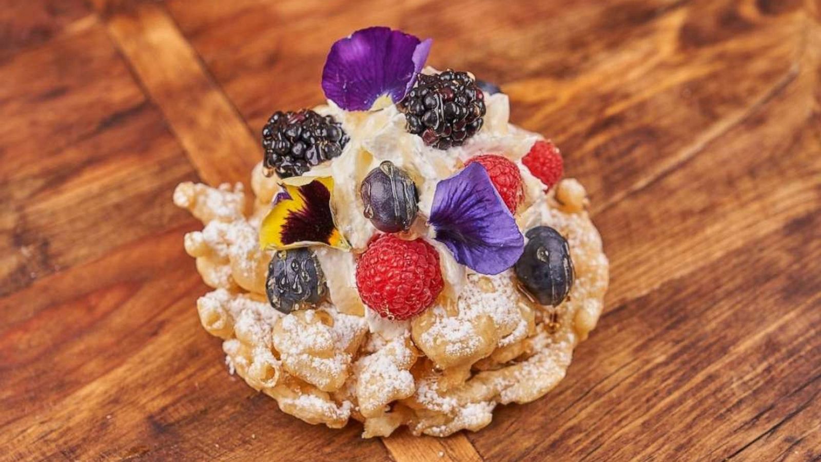 PHOTO: A lavender honey funnel cake with fresh berries and edible flowers served at Dollywood.