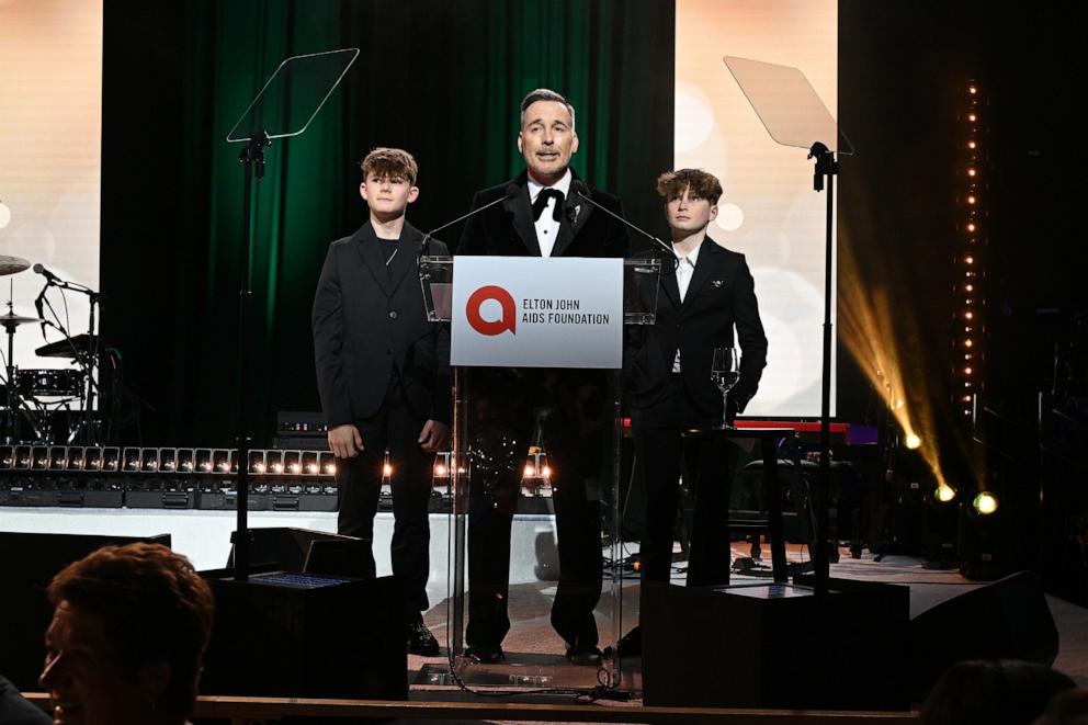 PHOTO: Zachary Furnish-John, David Furnish and Elijah Furnish-John speak onstage during Elton John AIDS Foundation's 33rd Annual Academy Awards Viewing Party on March 02, 2025 in West Hollywood, California.