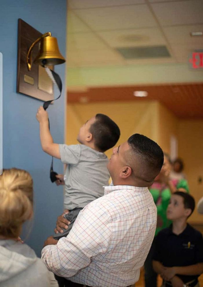 PHOTO: Gabe Rodriguez rings the bell with his father after beating leukemia.