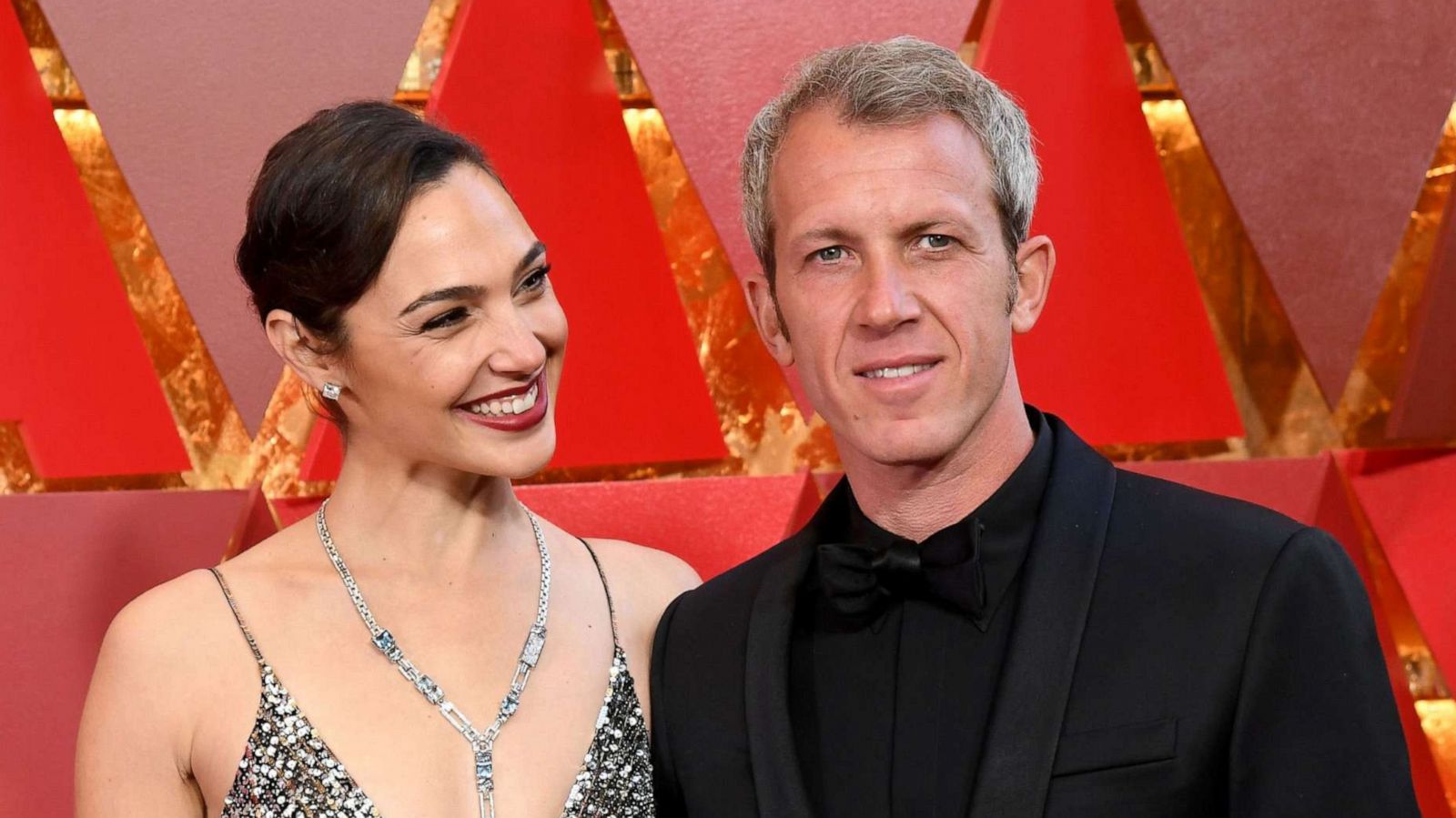 PHOTO: Gal Gadot and her husband Yaron Varsano, right, arrive for the 90th annual Academy Awards, March 4, 2018, in Hollywood, Calif.