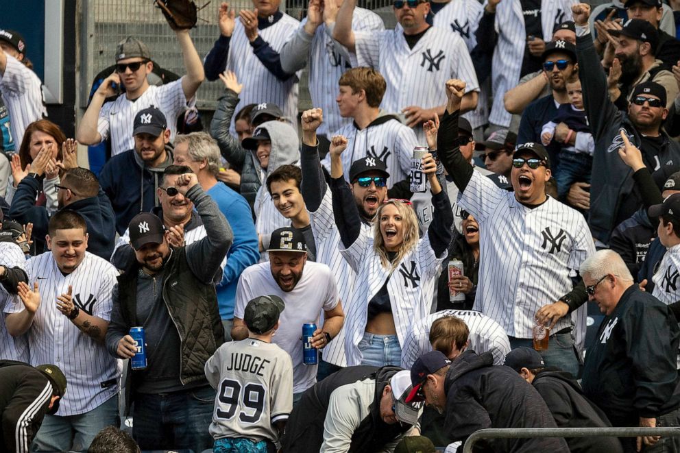 PHOTO: FILE - Fans of the New York Yankees cheer after a home run during the 2022 Major League Baseball Opening Day game against the Boston Red Sox, April 8, 2022 at Yankee Stadium in the Bronx borough of New York City.