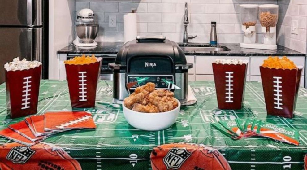 PHOTO: A game day spread with individual chip and popcorn containers and air fried chicken wings.