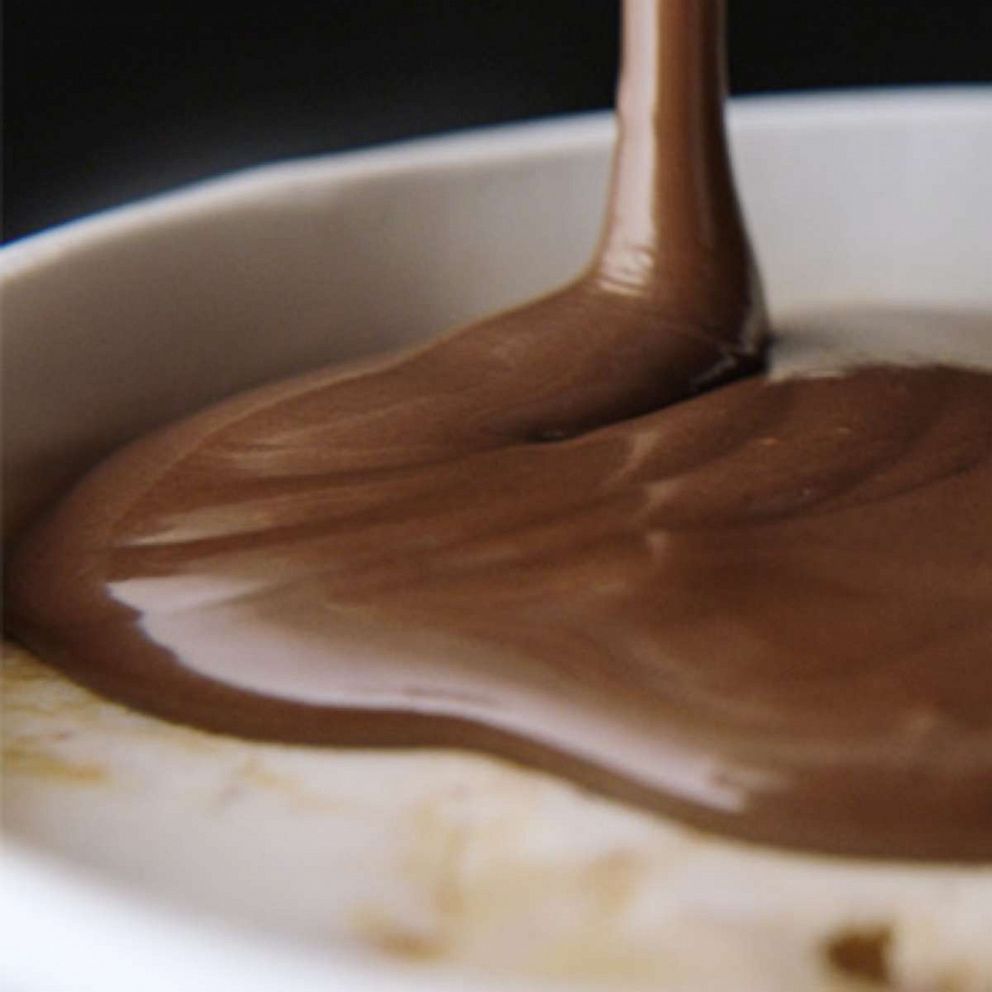 PHOTO: A layer of chocolate ganache poured over a pint of Ben & Jerry's ice cream.