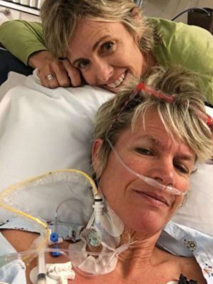 PHOTO: Genie Kilpatrick recovering in the hospital with wife, Sheri Norris, by her side.