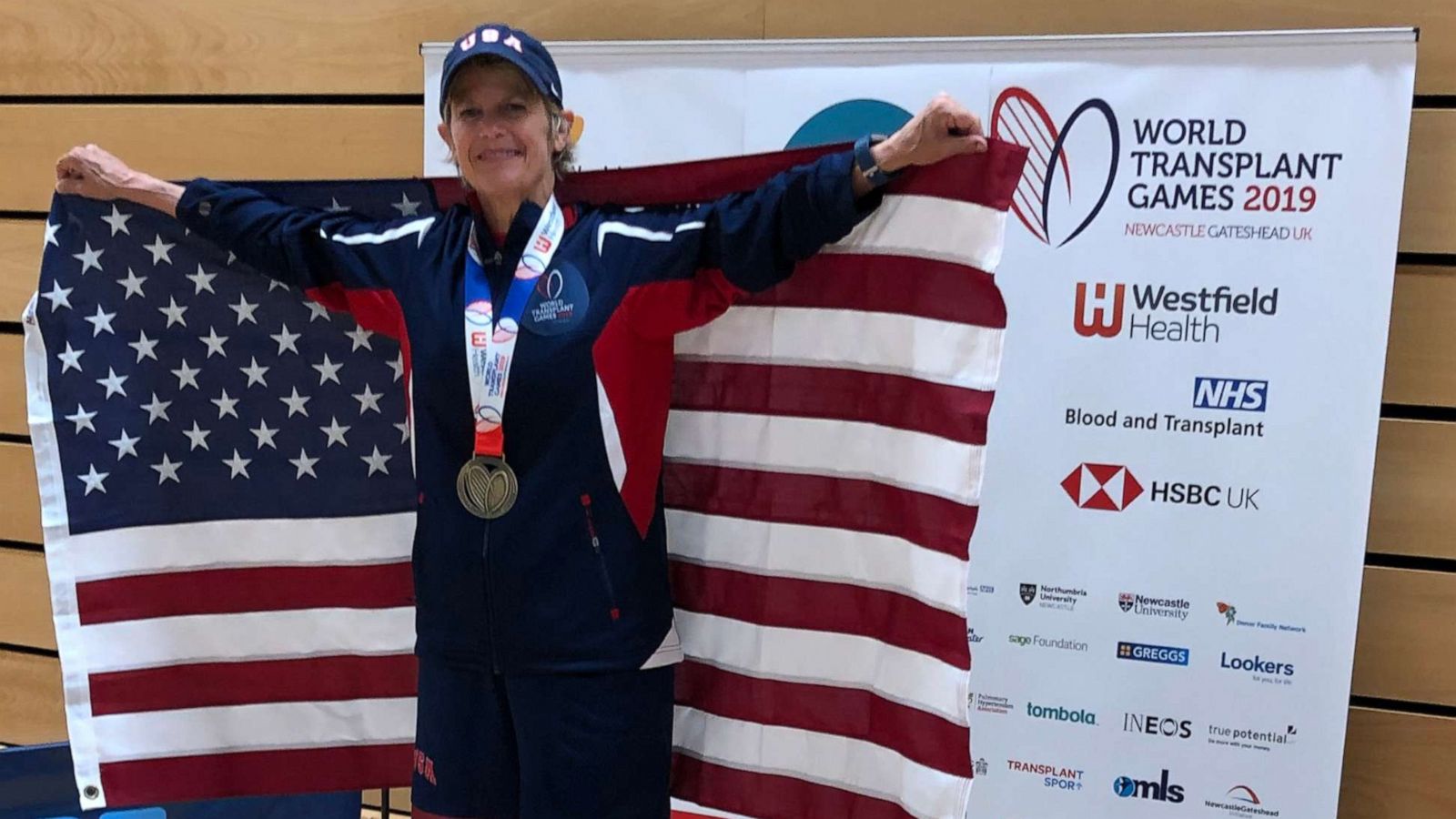 PHOTO: Genie Kilpatrick poses with her gold metal and the USA flag at the 2019 World Transplant Games.