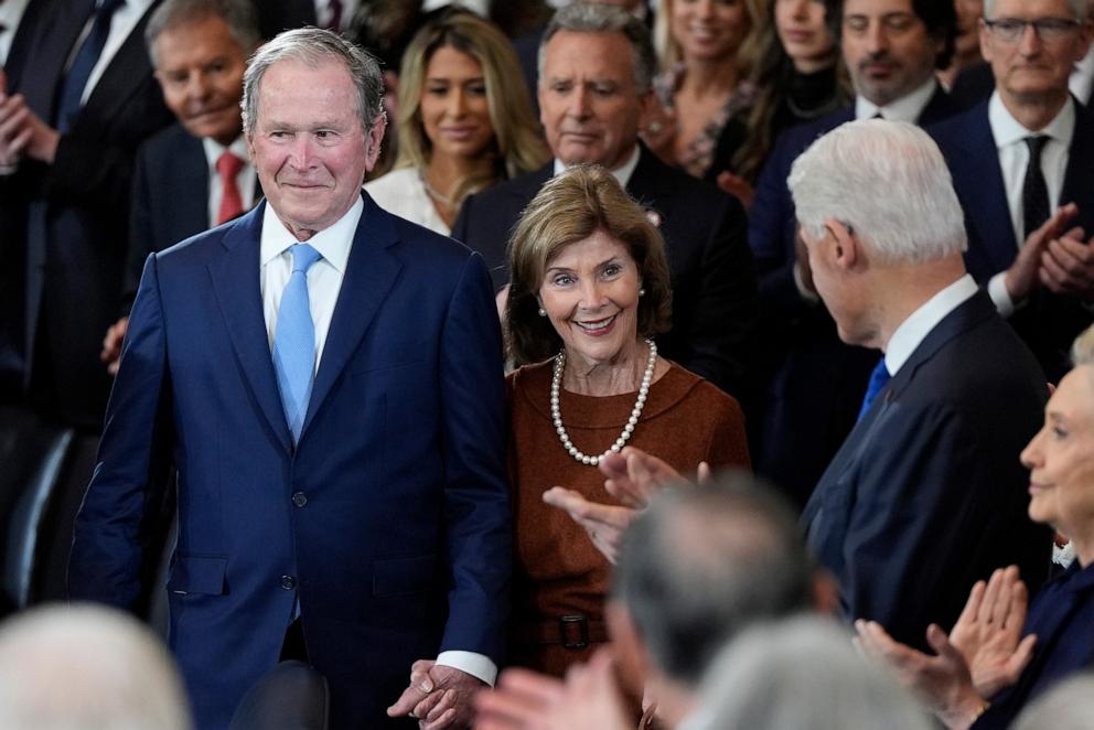 PHOTO: Former President George W. Bush and Laura Bush arrive as former President Bill Clinton watches before the 60th Presidential Inauguration in the Rotunda of the U.S. Capitol in Washington, Monday, Jan. 20, 2025.