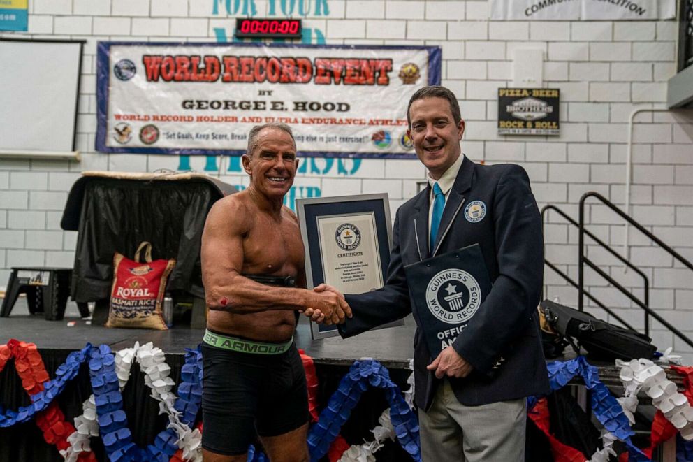 PHOTO: George Hood, 62, is presented a Guinness World Record title for holding a plank for eight hours, 15 minutes and 15 seconds at 515 Fitness in Plainfield, Ill., Feb. 15, 2020.