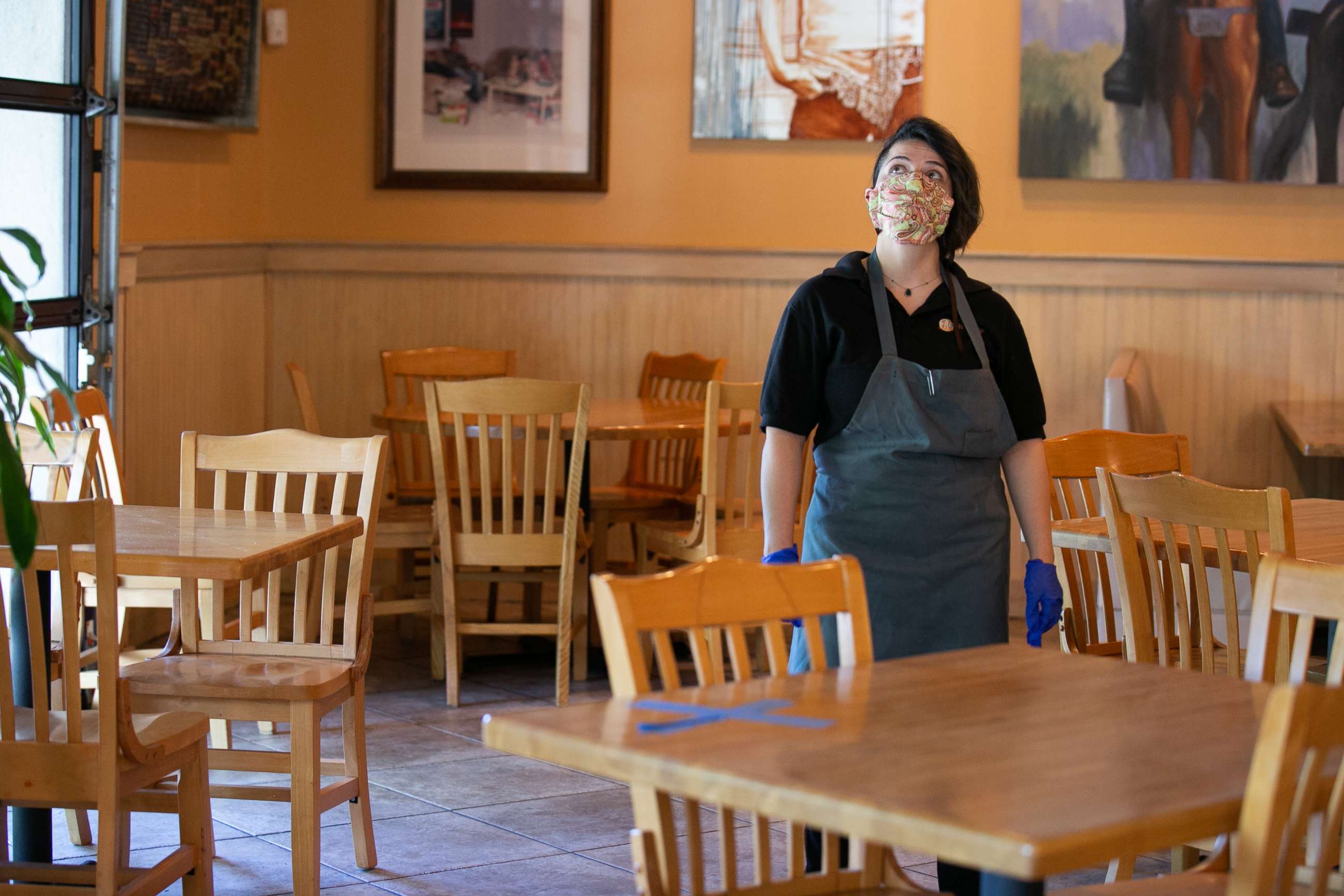 PHOTO: Manager Keni Quintero walks through the dining room of  the J. Christopher's restaurant in Brookhaven, Ga., April 27, 2020.