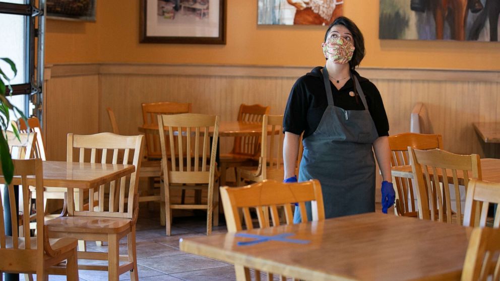 PHOTO: Manager Keni Quintero walks through the dining room of the J. Christopher's restaurant in Brookhaven, Ga., April 27, 2020.