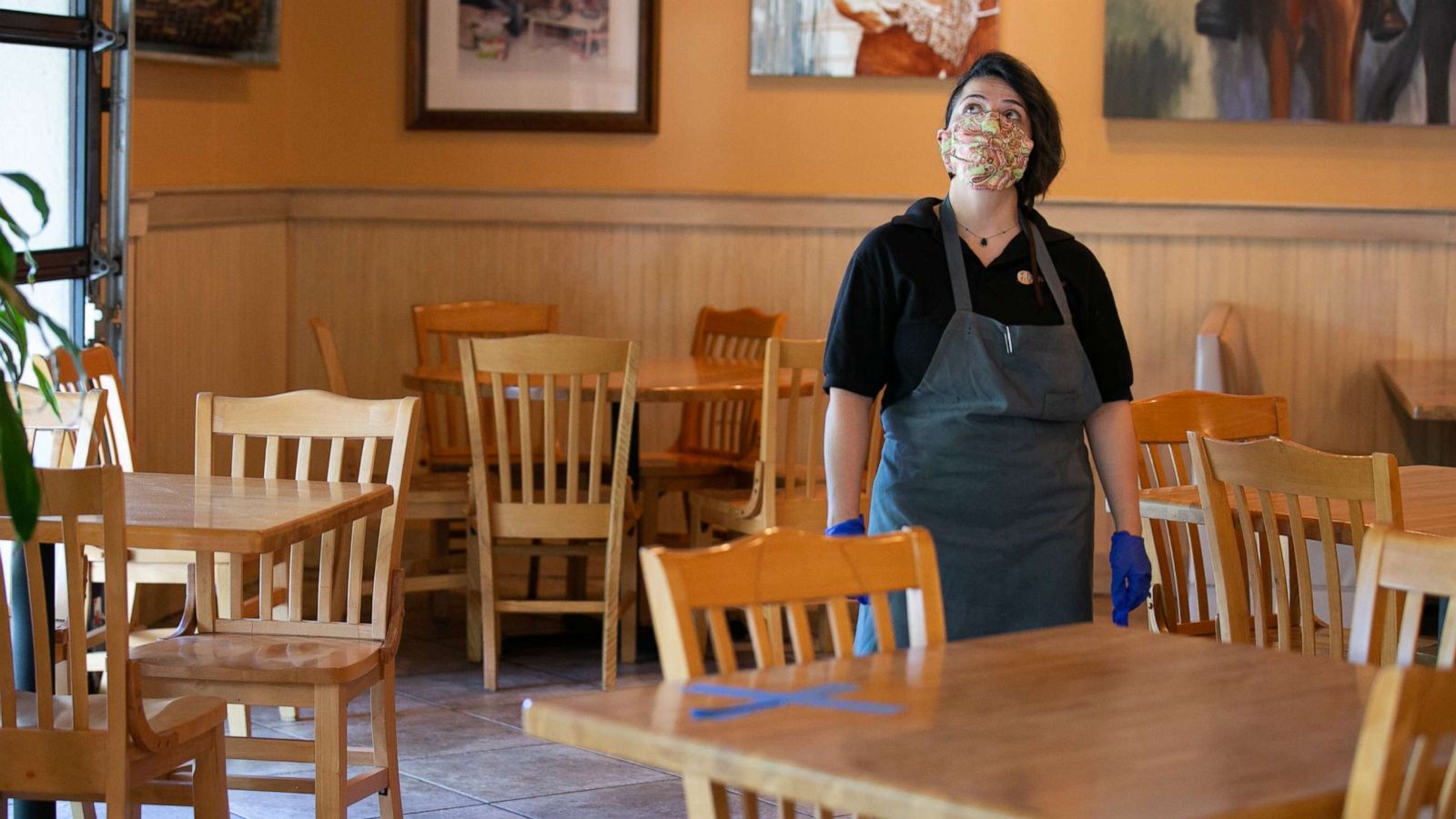 PHOTO: Manager Keni Quintero walks through the dining room of the J. Christopher's restaurant in Brookhaven, Ga., April 27, 2020.