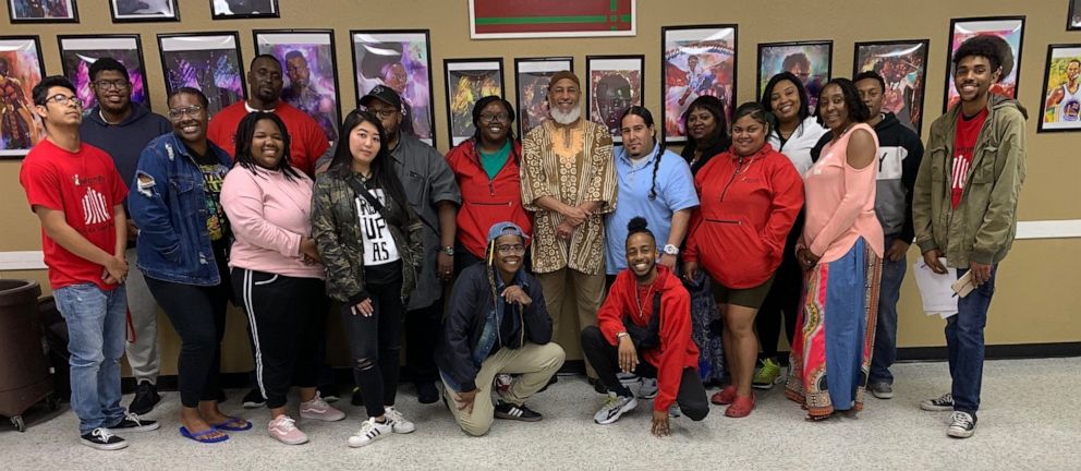 PHOTO: Dr. Jaleel Abdul-Adil poses with participants during a hip-hop therapy training session in Sacramento.