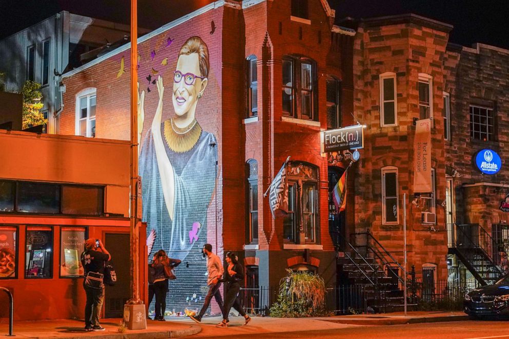 PHOTO: People gather under a mural of Supreme Court Justice Ruth Bader Ginsburg in the U Street neighborhood in Washington, Sept. 18, 2020, after the announcement that Ginsburg died of metastatic pancreatic cancer at age 87.