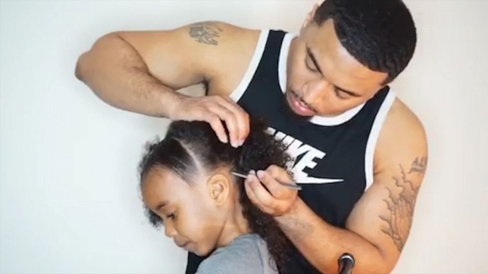 PHOTO: Treach Hill styles his 7-year-old daughter Breeze Hill's hair in Aurora, Ill. The father and daughter have thousands of followers on Instagram where they share videos of Hill doing her hair.