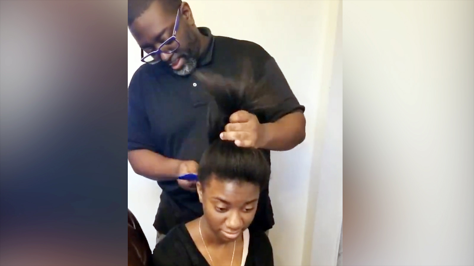 PHOTO: Lufrey Jonas does his 14-year-old daughter Arielle's hair in Baltimore.