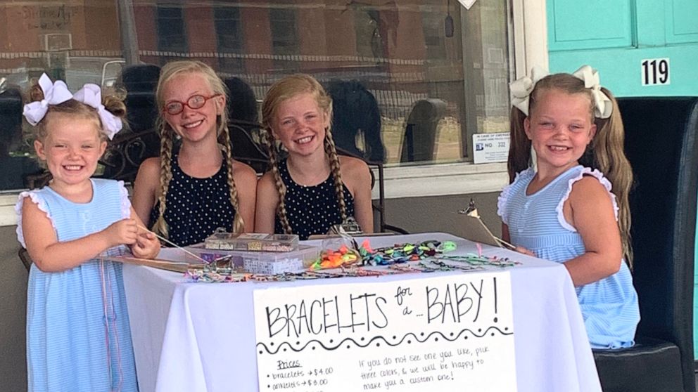 PHOTO: Evelyn, 4, Susanna, 11, Mary Anson, 11 and Eleanor Tate, 7, sit outside their mother's Mississippi salon making and selling bracelets in hopes to raise money so their parents can adopt a baby. 