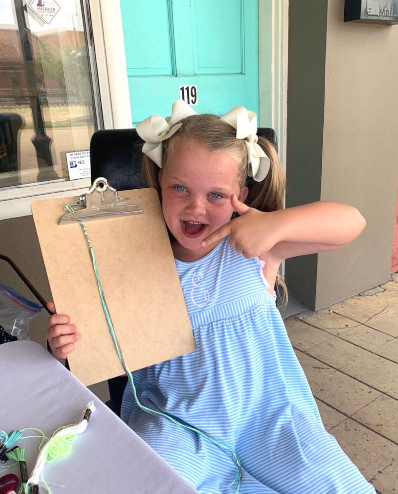 PHOTO: Elenor Tate, 7, smiles with a bracelet she made herself.