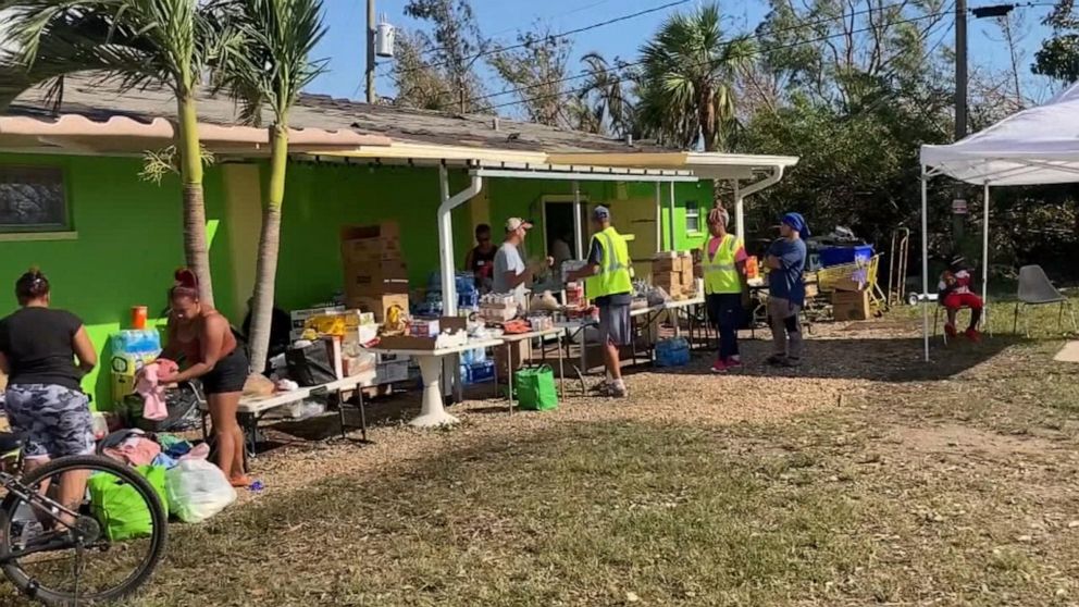 PHOTO: People collect food  and supplies outside the Gladiolus Food Pantry in Harlem Heights, Fla., Oct. 1, 2022. The Gladiolus Food Pantry usually hands out supplies on Wednesdays, but had to suspend distribution due to Hurricane Ian.