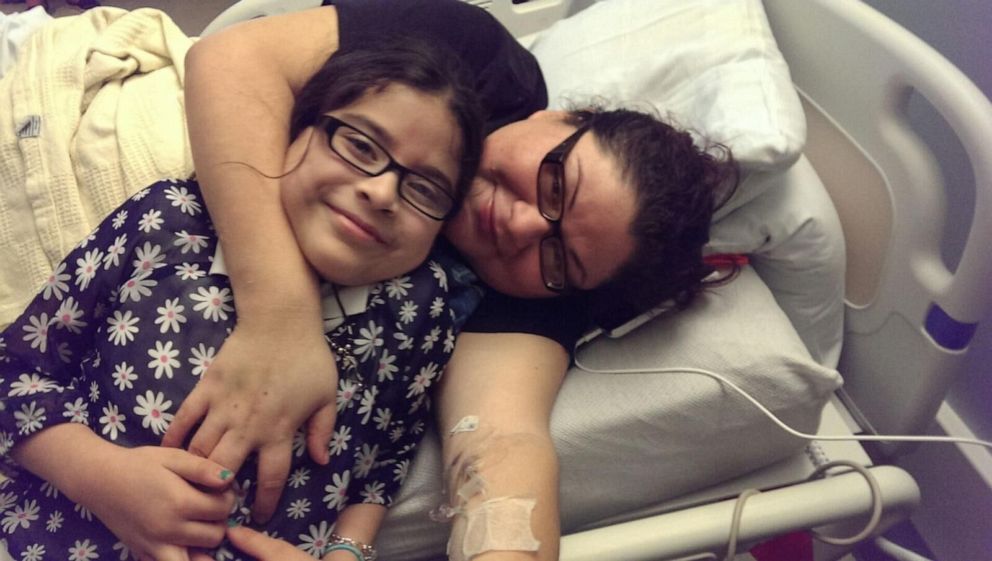 PHOTO: Gloria Suarez poses with her daughter Jazmin after being paralyzed during spinal surgery.
