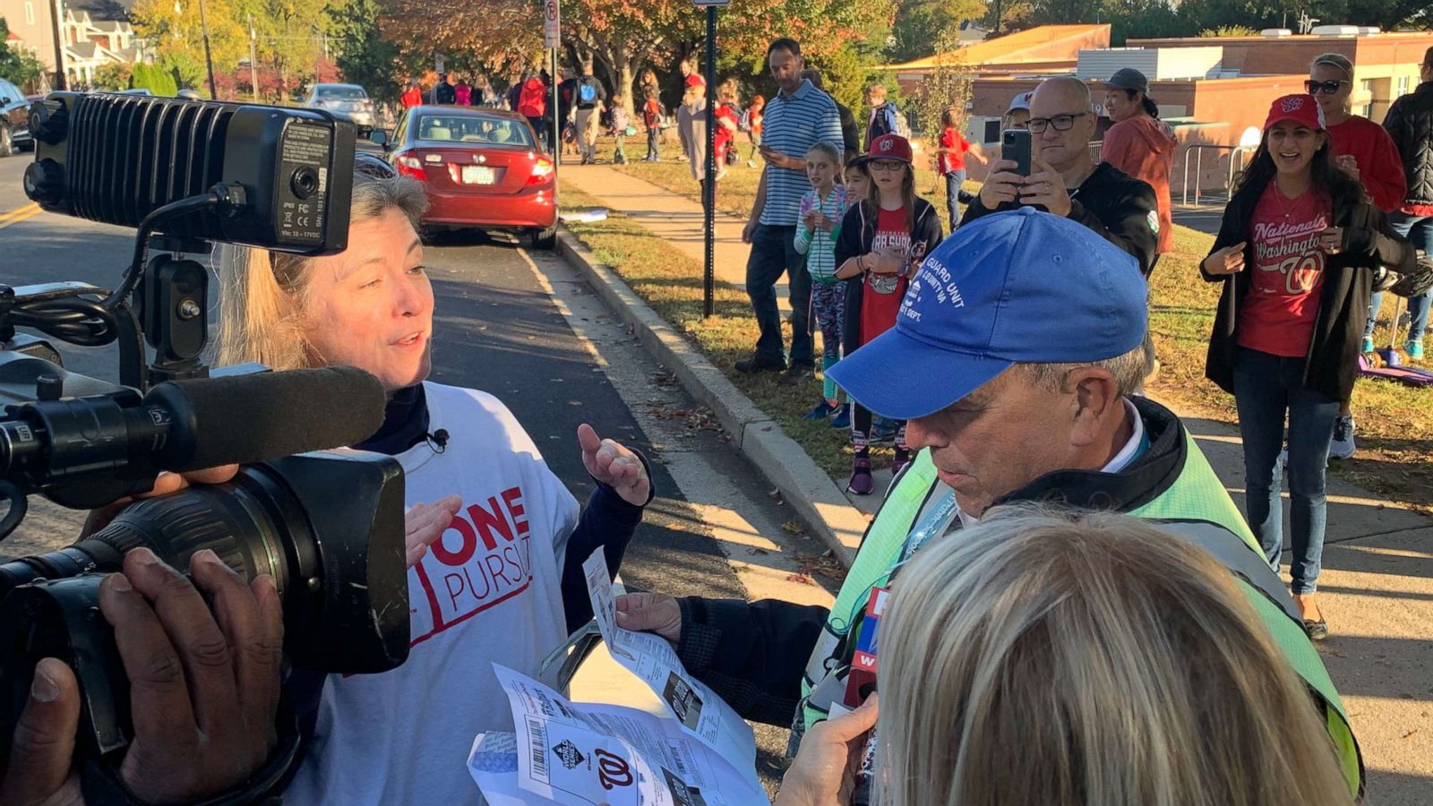 PHOTO: Beloved crossing guard surprised with World Series tickets by community.