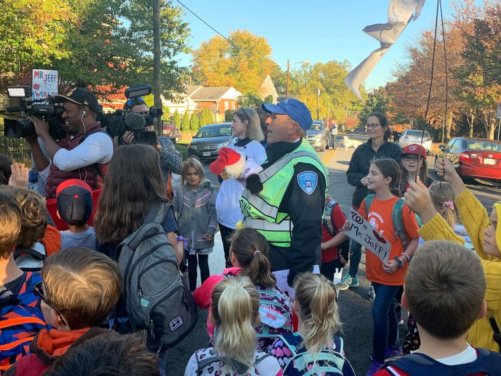 PHOTO: Beloved crossing guard surprised with World Series tickets by community.