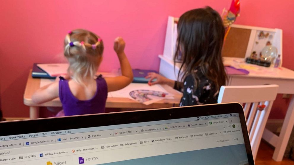 PHOTO: Sara Pereschino's daughters Kenley, 7, and Lucca, 4, do virtual learning while she works at home.