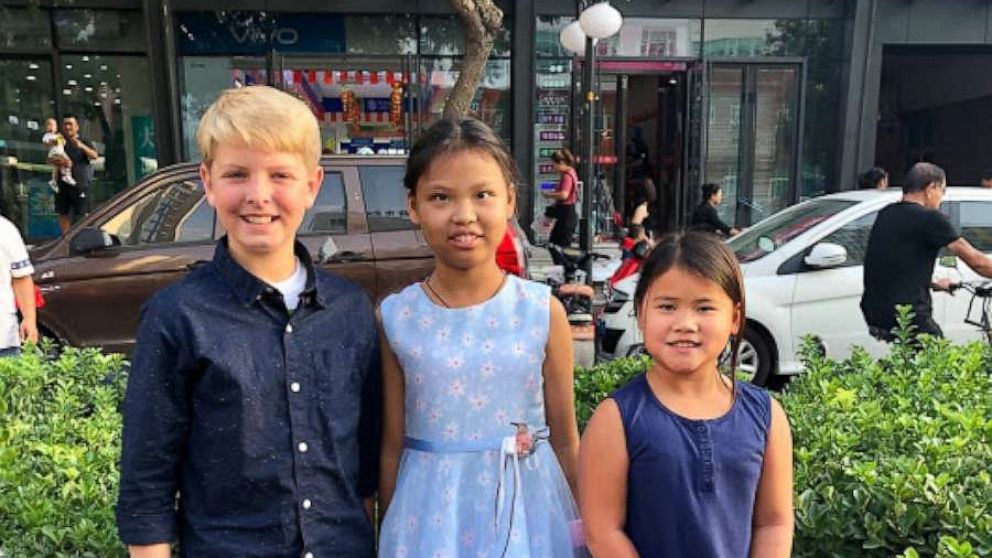 PHOTO: Mia, center, poses in China with two of her adopted siblings.