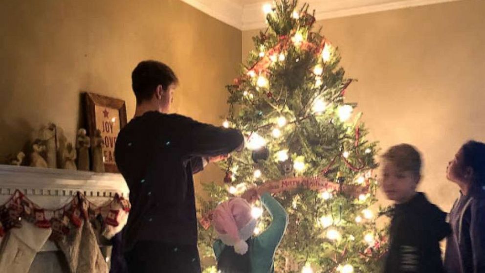 PHOTO: Kerry and David Mills' four children decorate the family's Christmas tree.