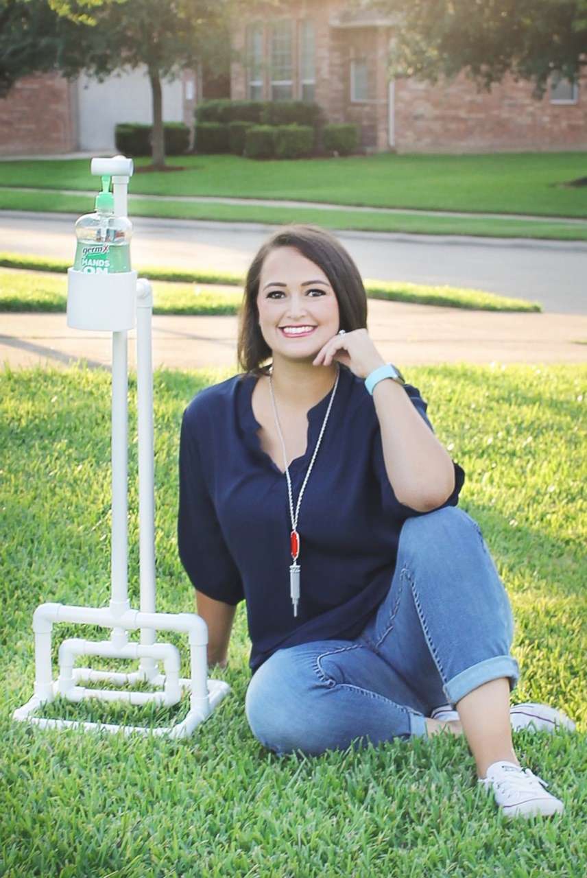 PHOTO: Ashley Martin, a teacher in Texas, poses next to a hands-free hand sanitizer station for her classroom.
