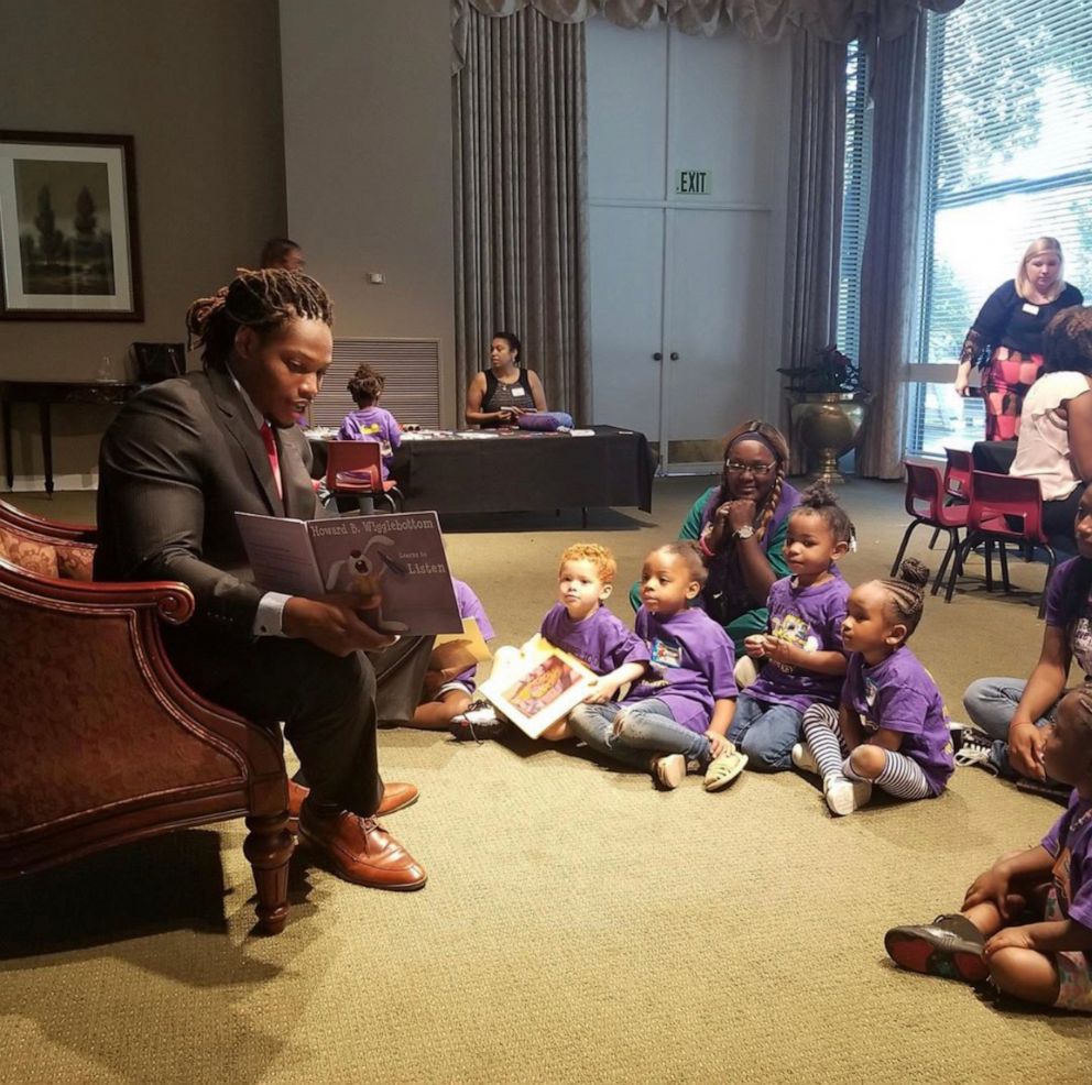 PHOTO: Caylin Moore reading to kids