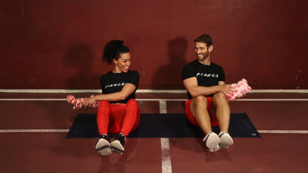 PHOTO: Engaged trainers Bree Branker and CJ Koegel demonstrate a couples workout at Chelsea Piers in New York City.