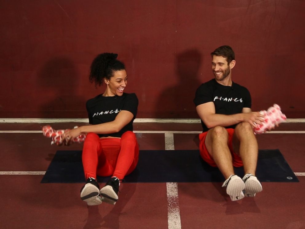 PHOTO: Engaged trainers Bree Branker and CJ Koegel demonstrate a couples workout at Chelsea Piers in New York City.