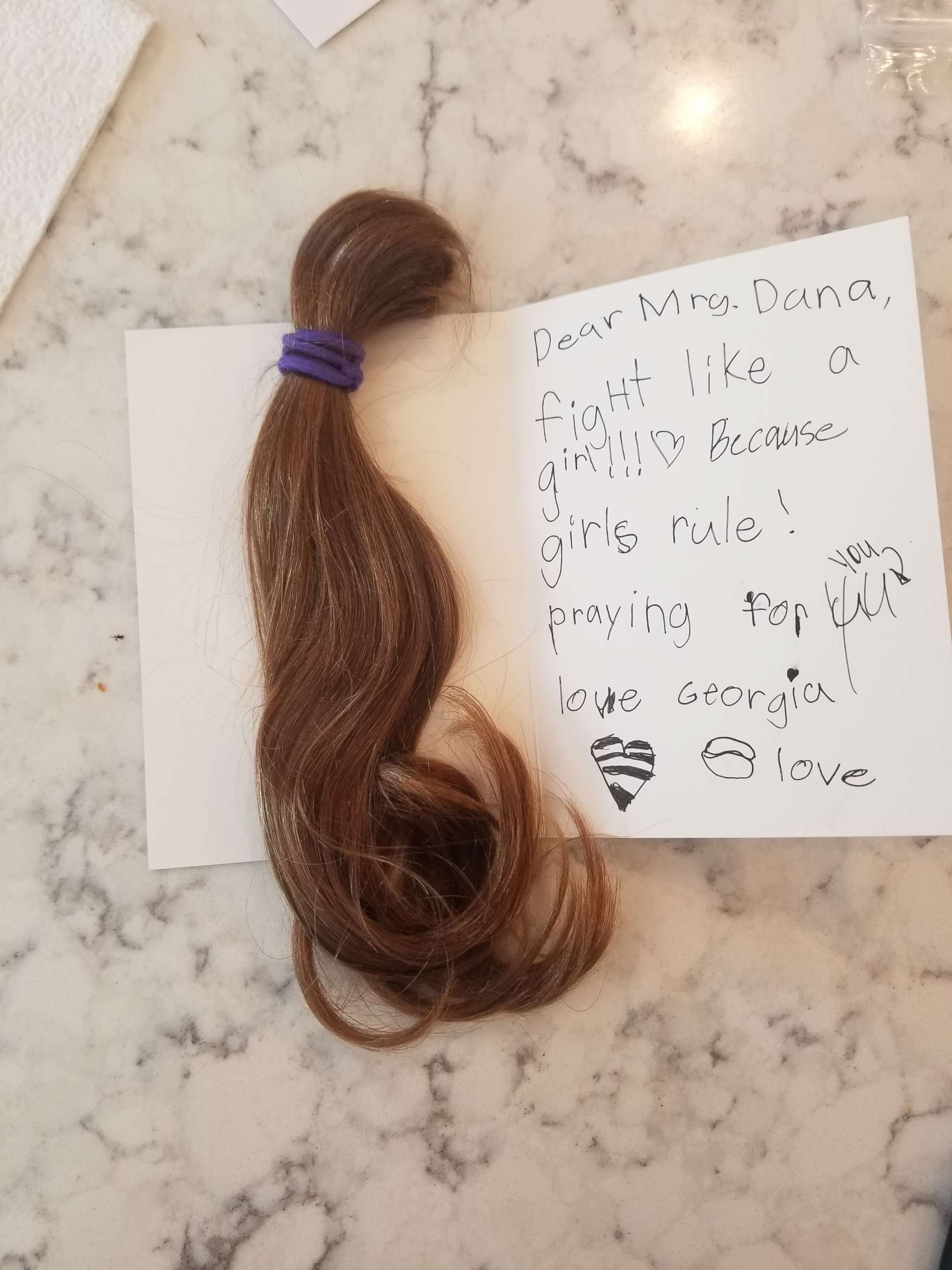 PHOTO: A 7-year-old girl donated her hair to Dana McSwain, who is battling cancer.