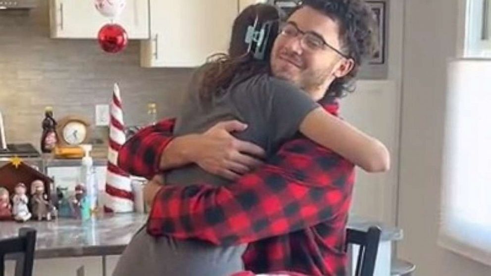Photo: Anthony Lyle hugs his sister Lauren after surprising her with the news that he has paid off student loan debt.