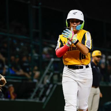 Sweetwater Valley's Sebastian Pino #6 looks on as Phenix City's Kinley Rasmus #16 celebrates while scoring a run at Howard J. Lamade Stadium on Saturday, Aug. 22, 2026 in South Williamsport, Pennsylvania. 