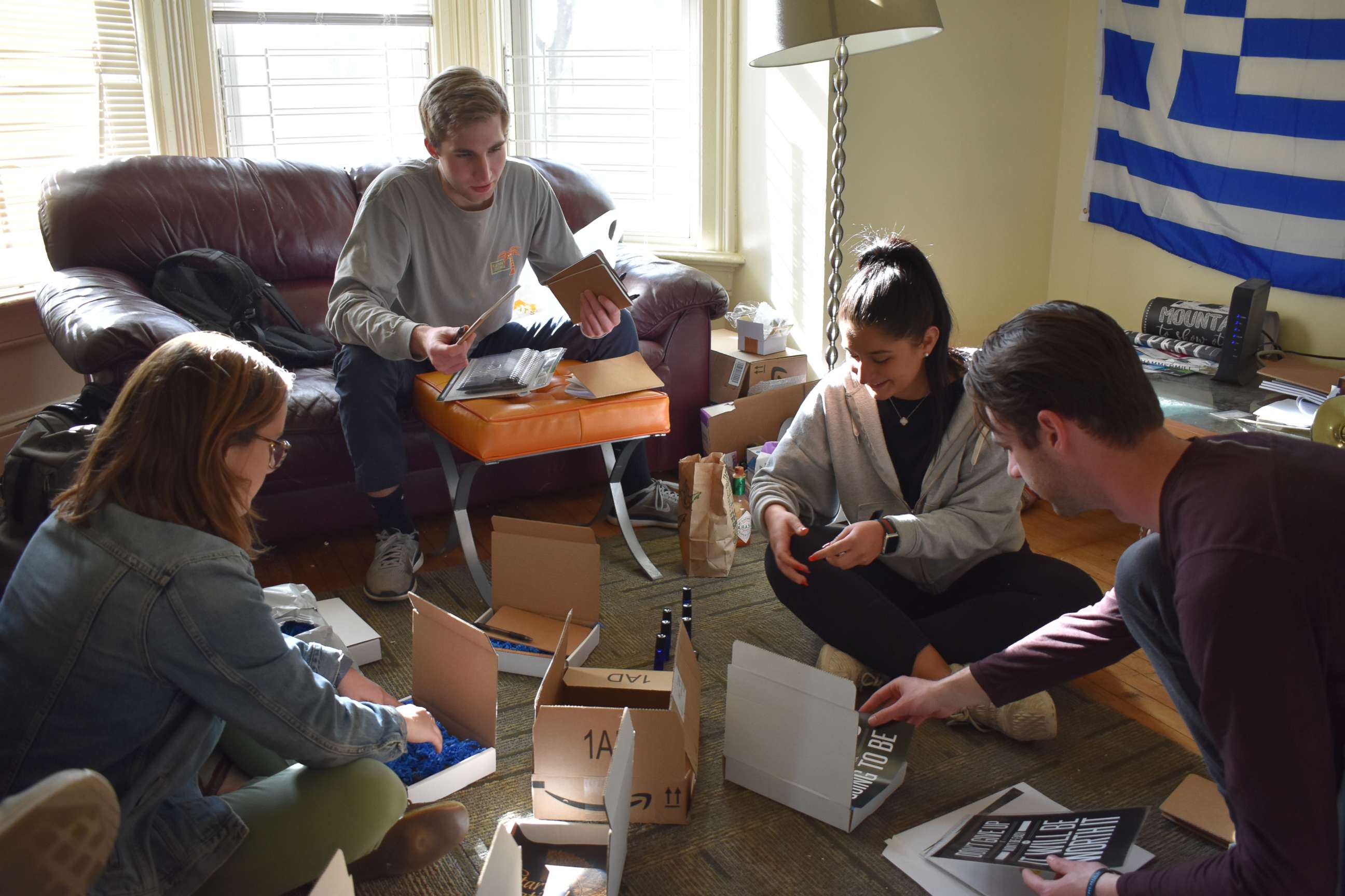 PHOTO: Mae Haggerty, Jonathan Constantine, Panagiota Roumeliotis and Isaac Haubrick-Feil assemble self-care boxes.