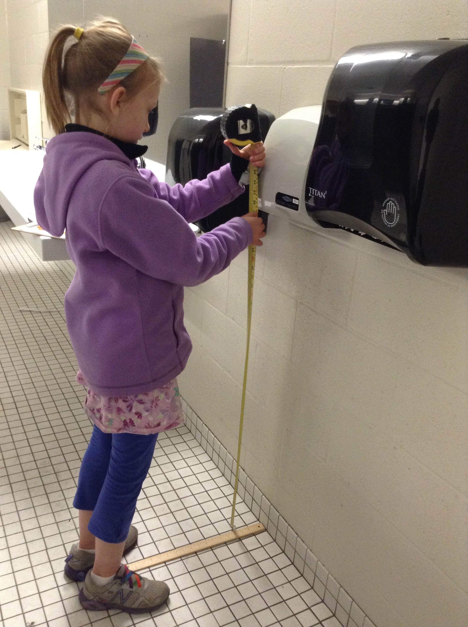 PHOTO: Nora Keegan, then 9, measures a hand dryer's volume in 2016.