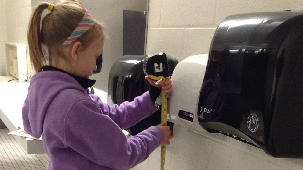 PHOTO: Nora Keegan, then 9, measures a hand dryer's volume in 2016.