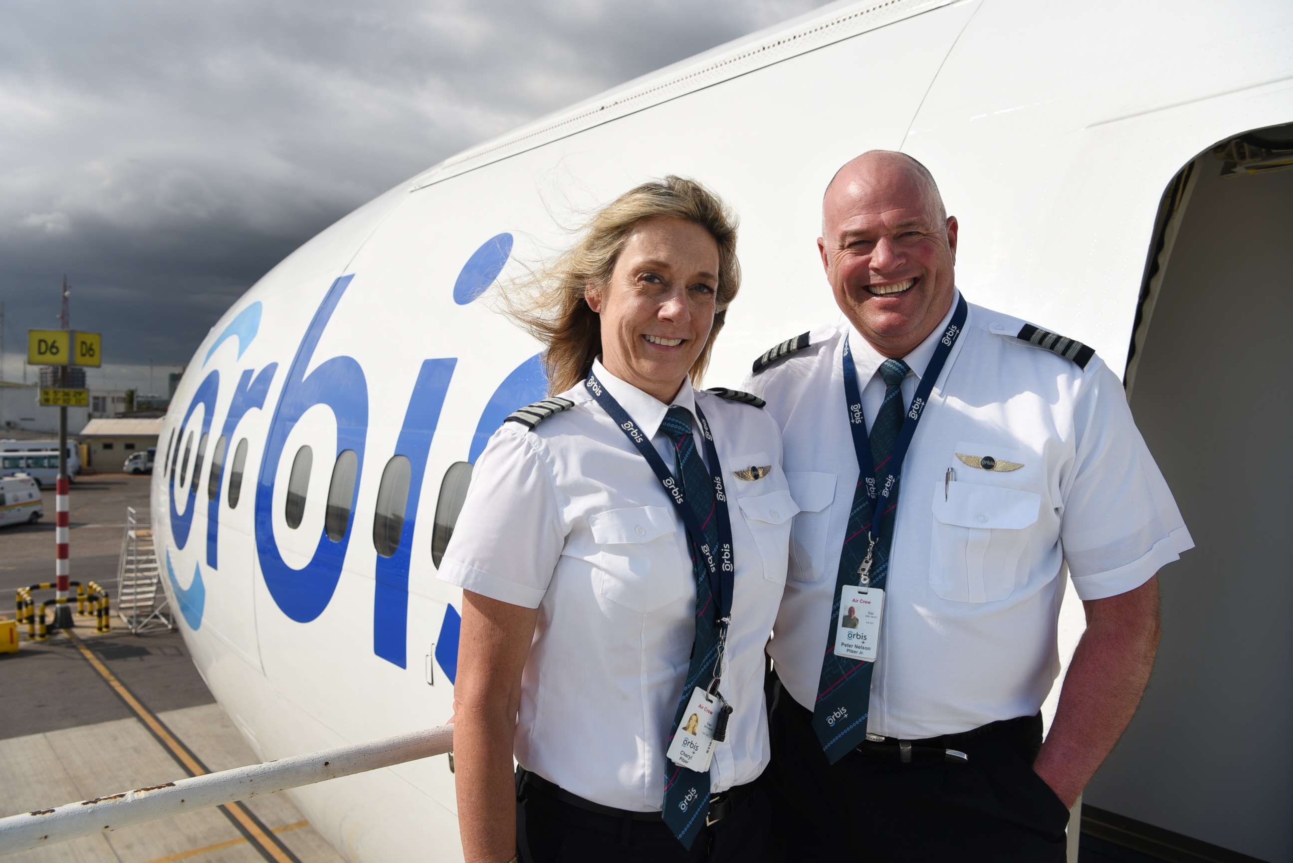 PHOTO: Peter and Cheryl Pitzer pose together outside an Orbis plane.